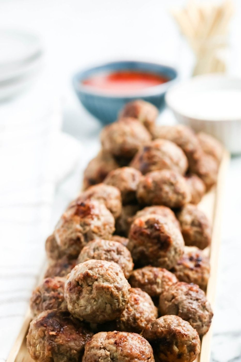 meatballs stacked on a platter on table