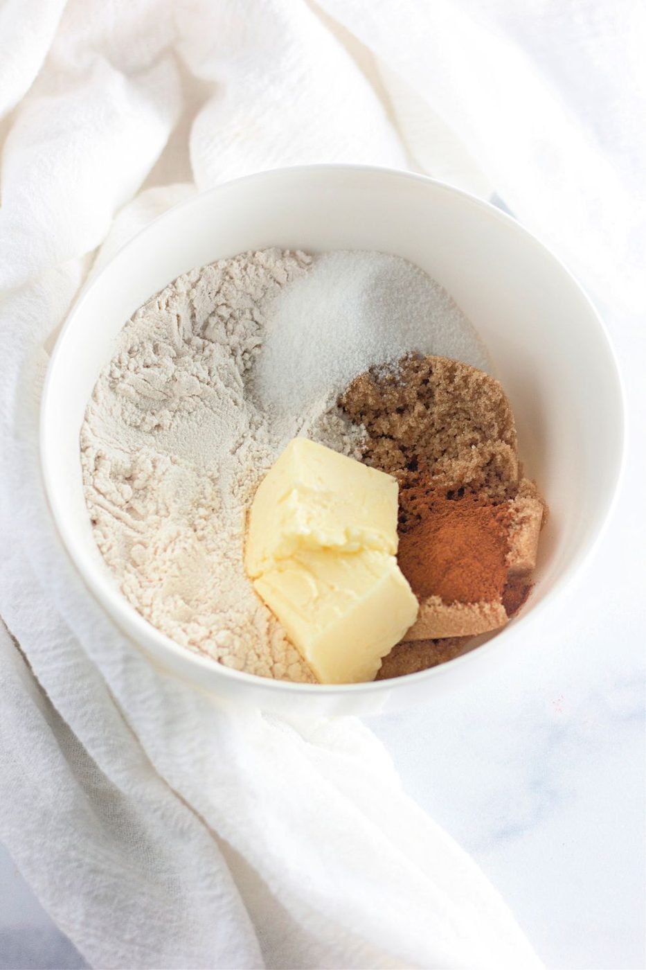 dry ingredients and butter in a bowl on table