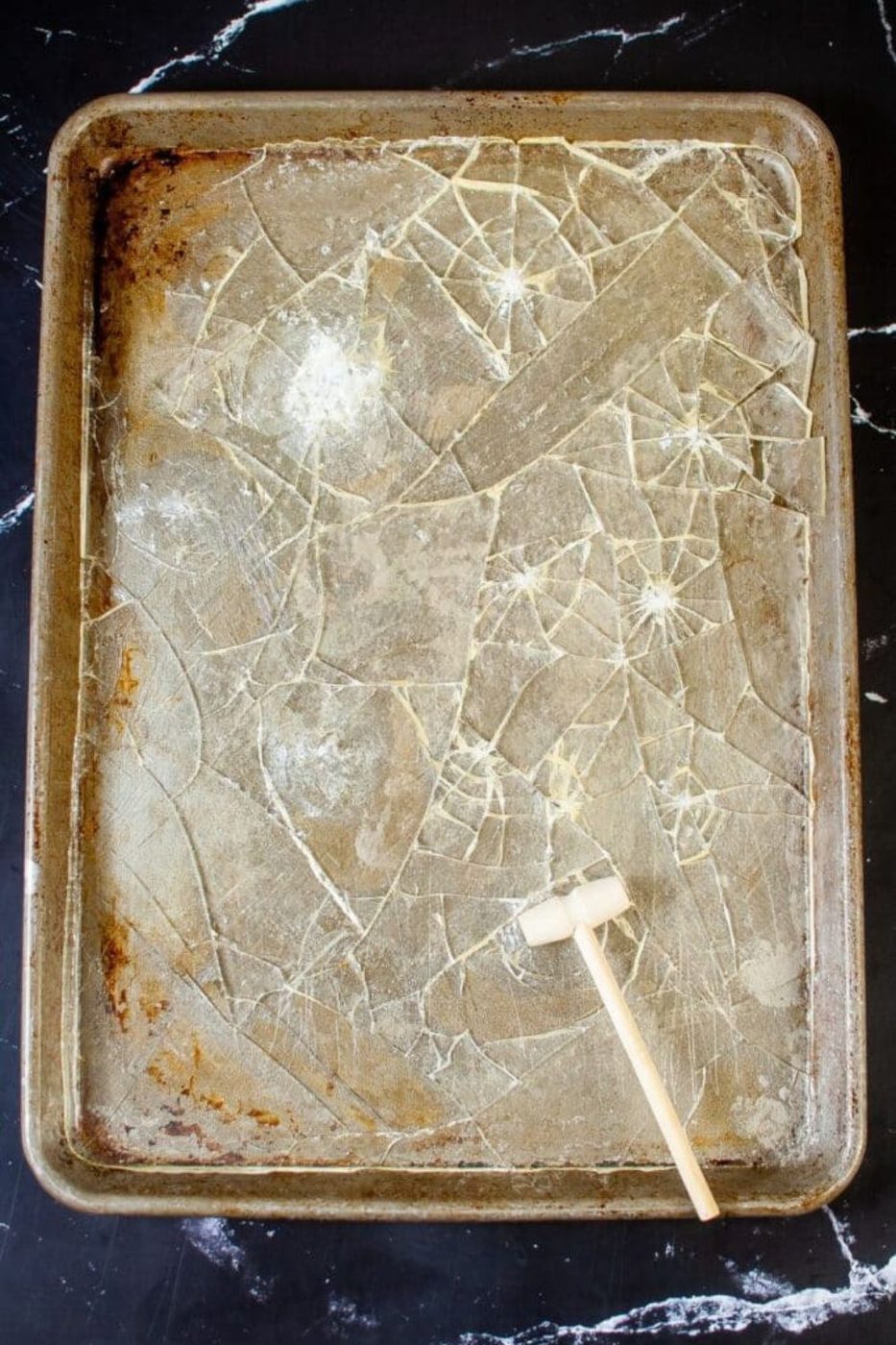 glass candy broken up in a sheet pan on table 