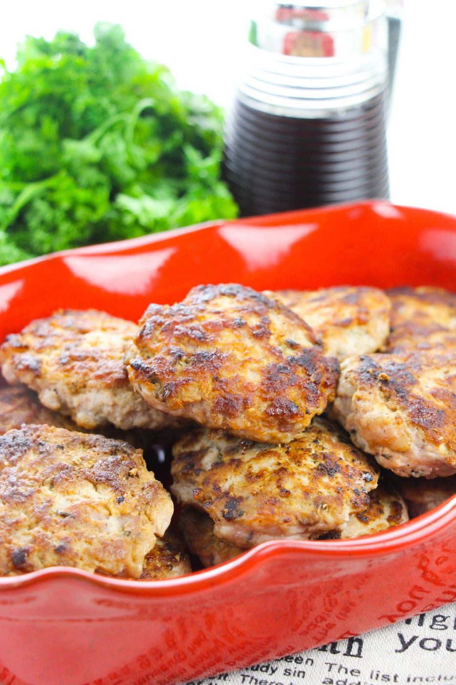 sausage patties in container with syrup behind it 