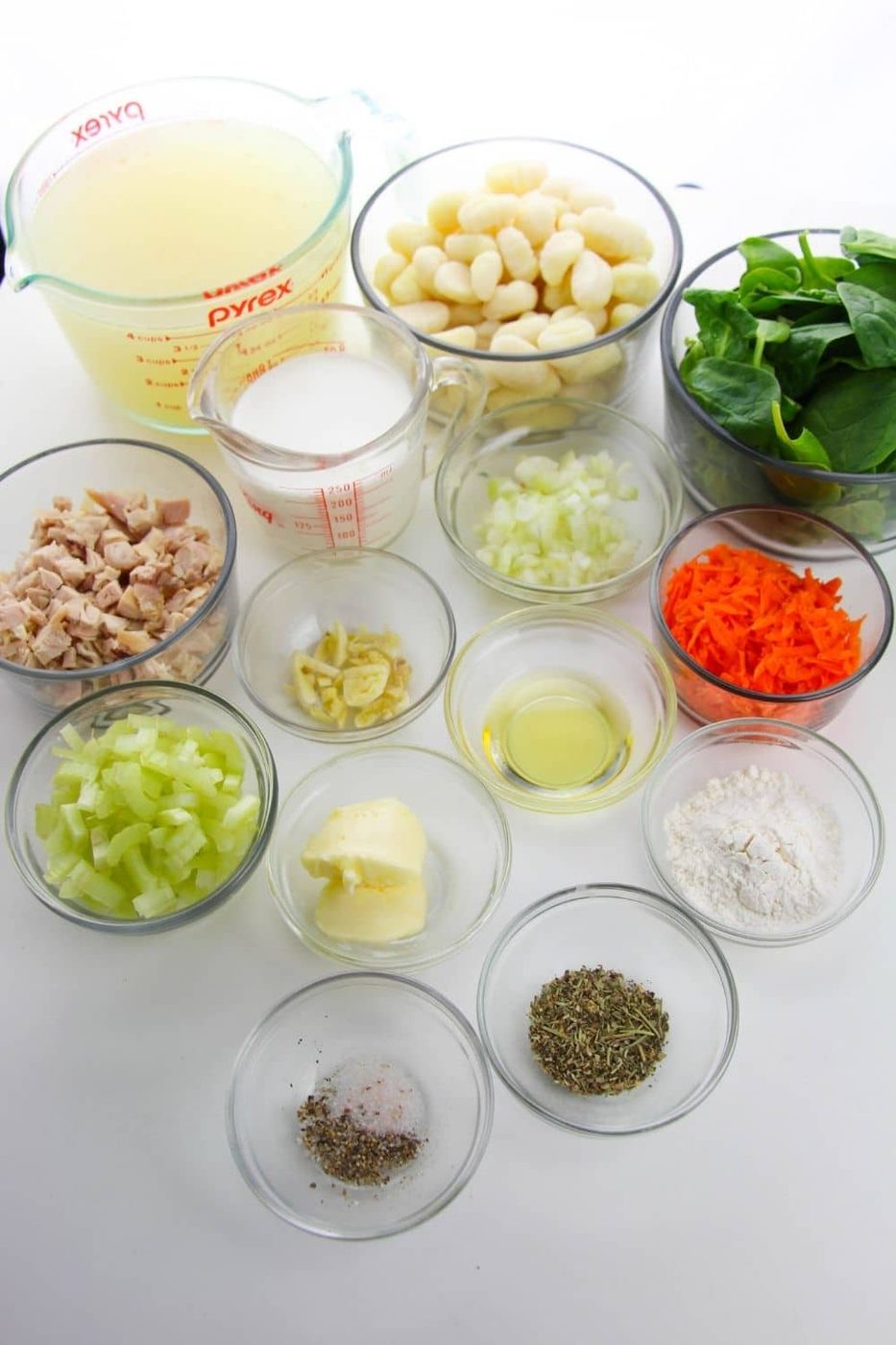 ingredients for gnocchi soup on white table