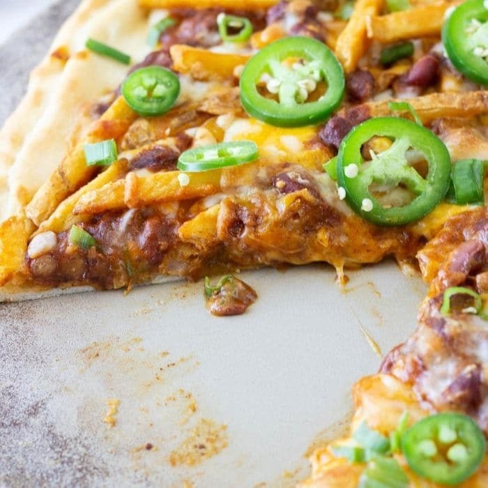 chili cheese pizza with a slice taken out