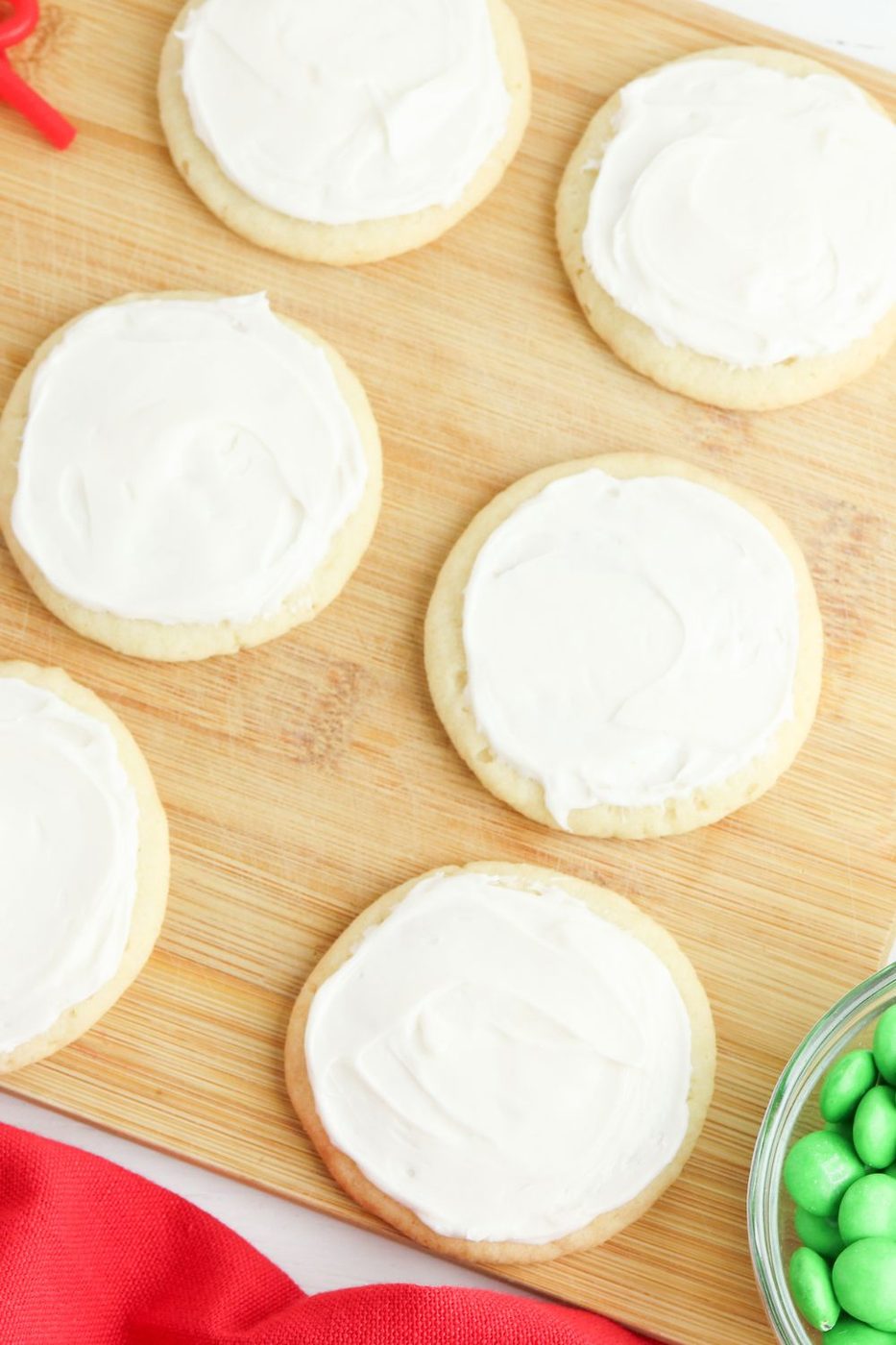 frosted sugar cookies on wooden board
