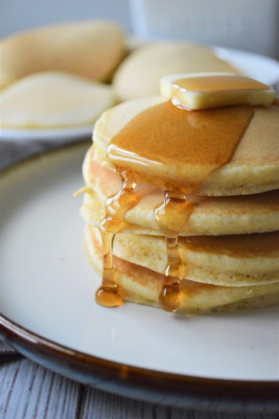 stack of pancakes with butter and syrup on top