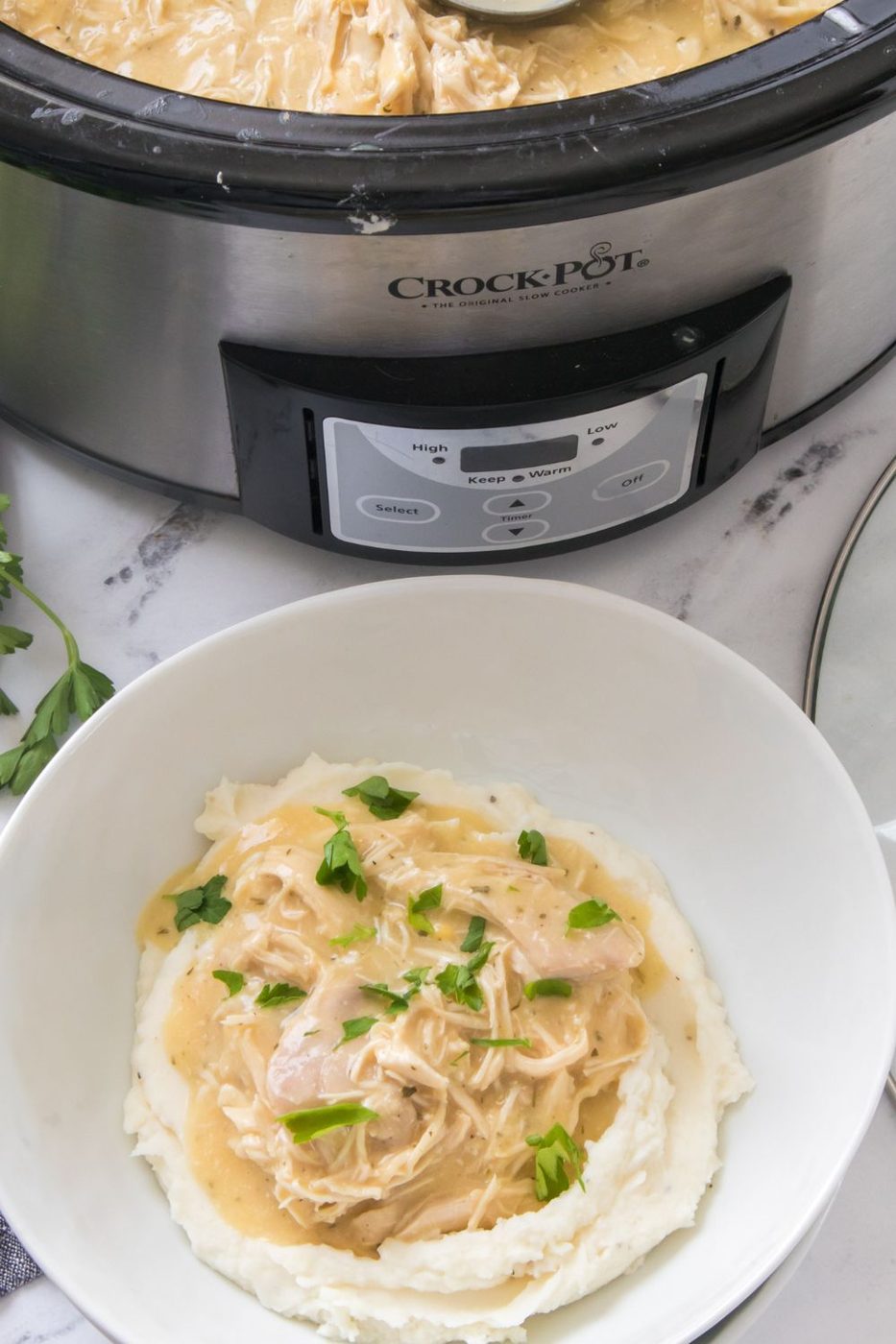 crock pot chicken and gravy served over mashed potatoes