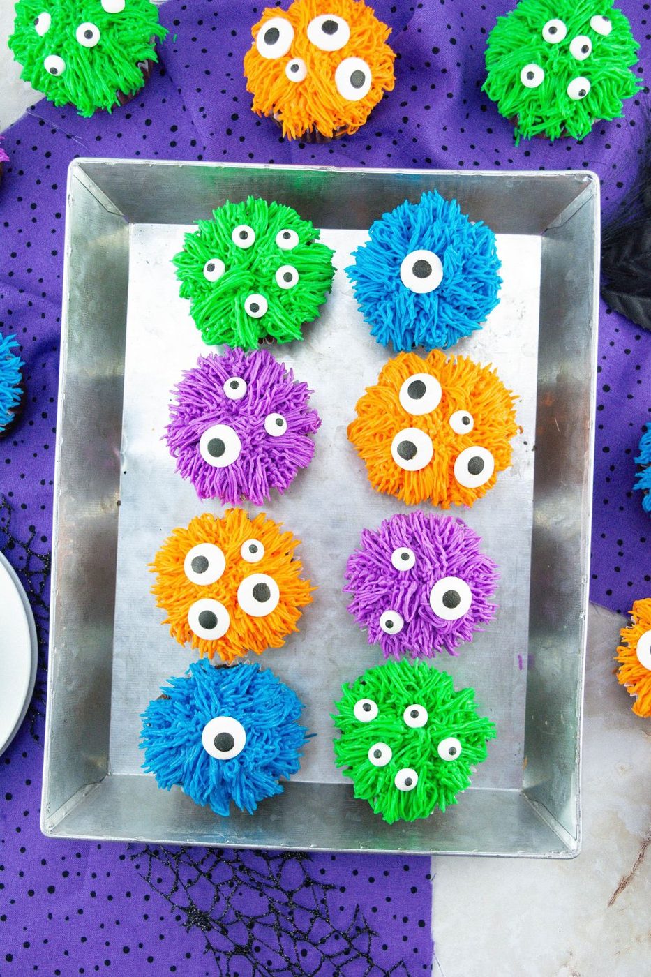 monster cupcakes in a metal serving tray on table 