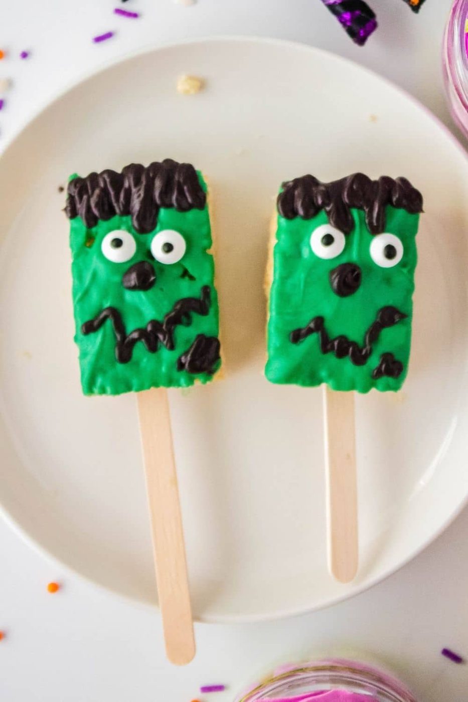 frankenstein treats on popsicle sticks on plate
