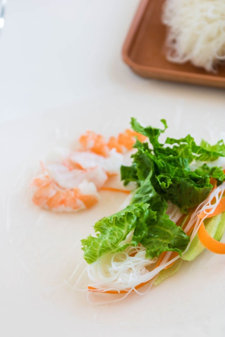 spring roll on a cutting board filled with vegetables and shrimp 