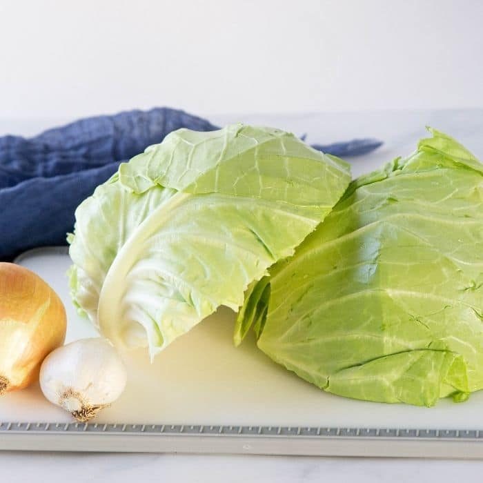 cabbage onion and garlic on cutting board on table