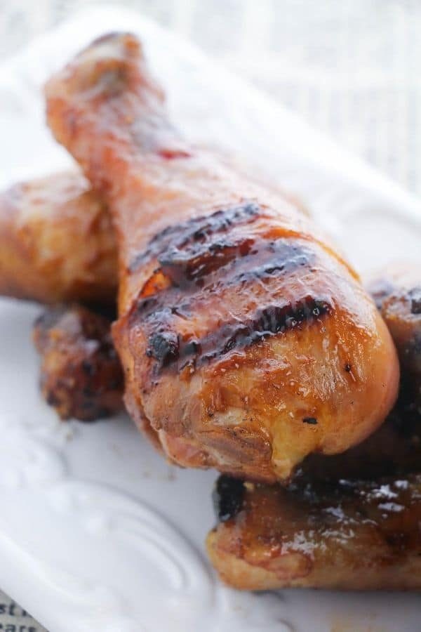 chicken legs cooked on white platter 