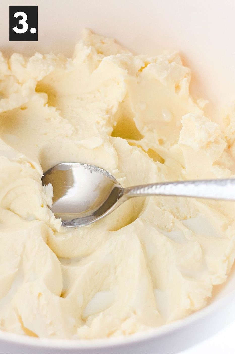 butter in a bowl with a spoon that has spread it around smooth