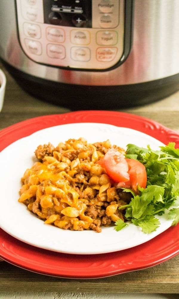 plate with taco pasta with instant pot behind it