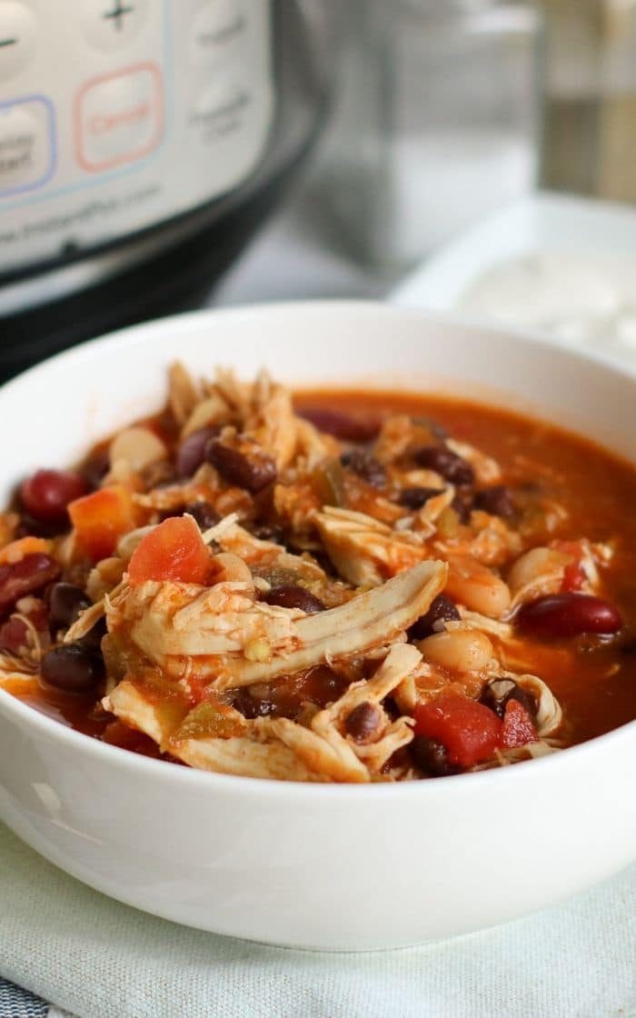 side view of a bowl of chicken chili with beans 