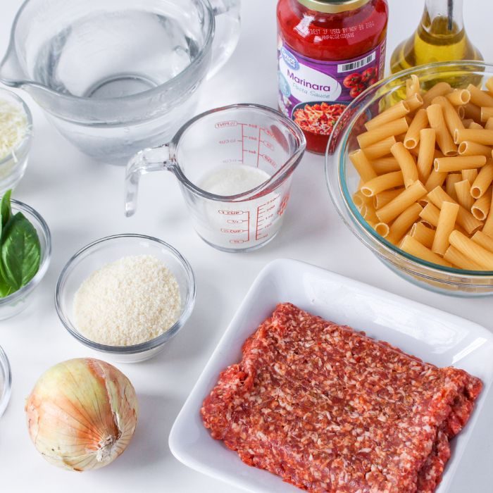 ingredients for rigatoni on marble table 