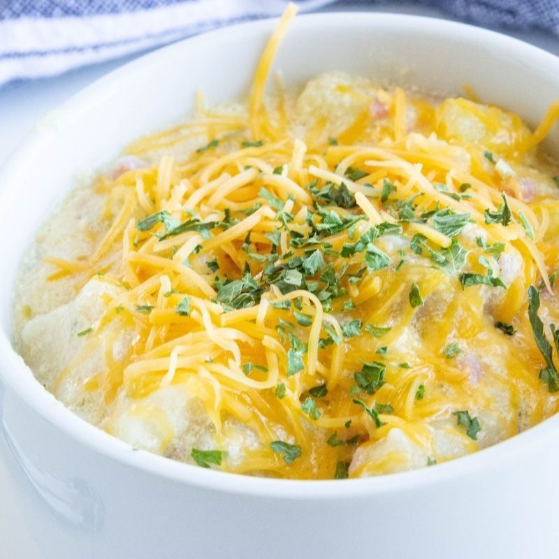 ham dumpling potato soup in a white bowl 