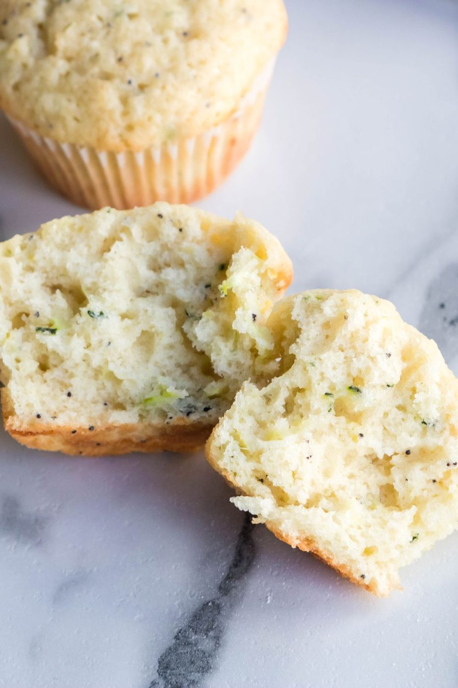 lemon poppyseed muffins tore in half on marble counter