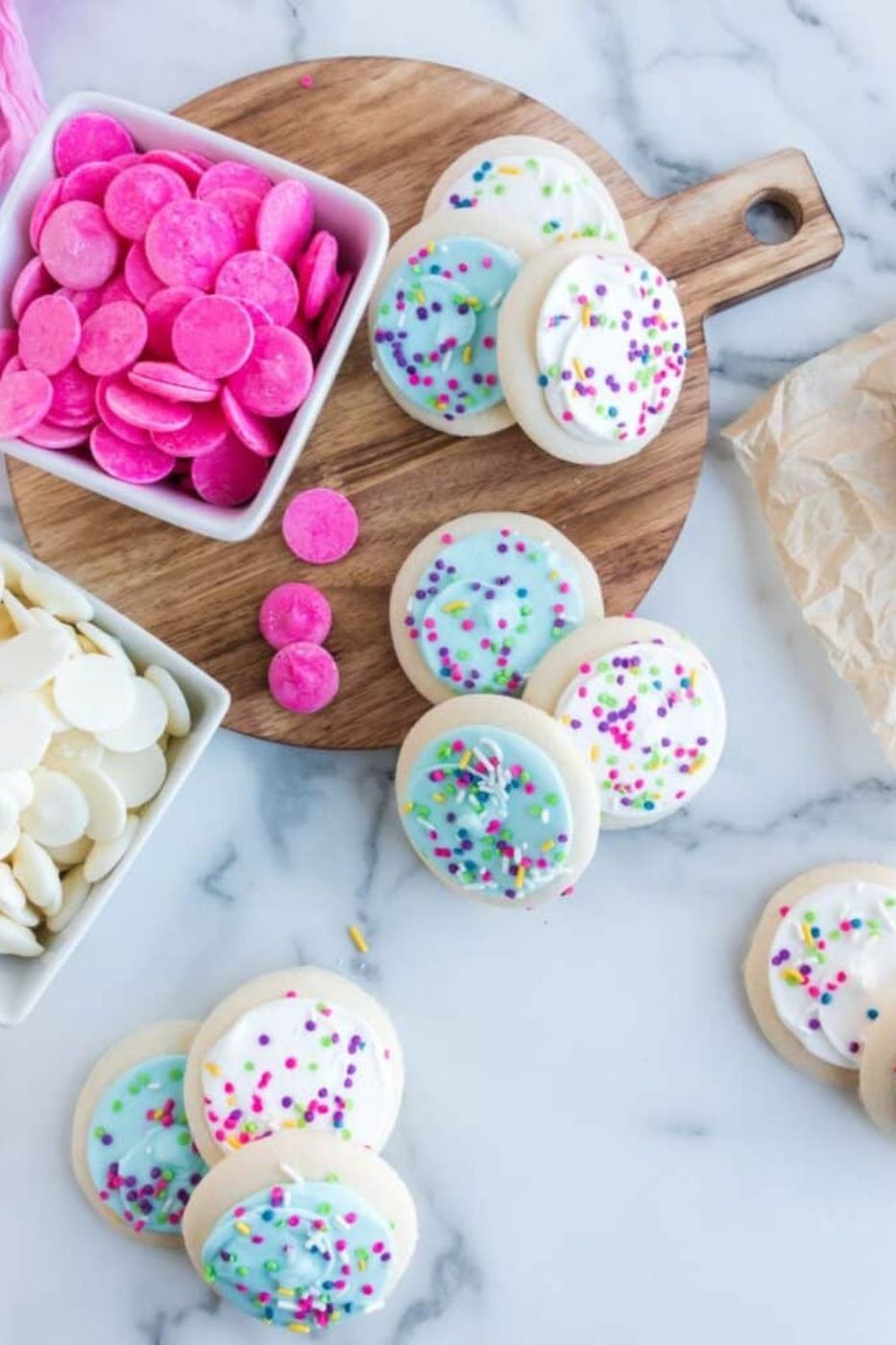 sugar cookies on table and bowls of candy melts 