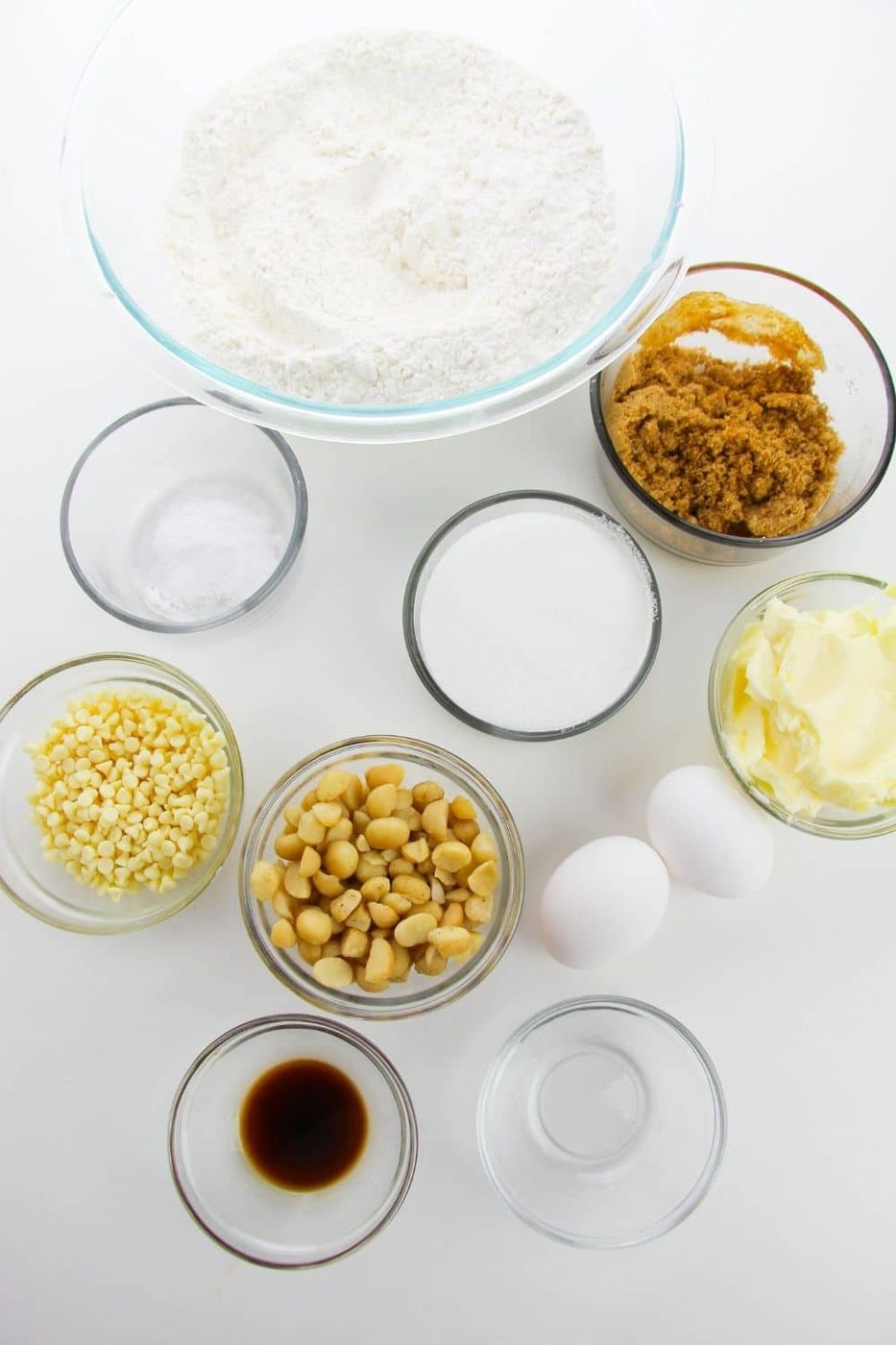 ingredients for macadamia cookies in glass bowls on counter 