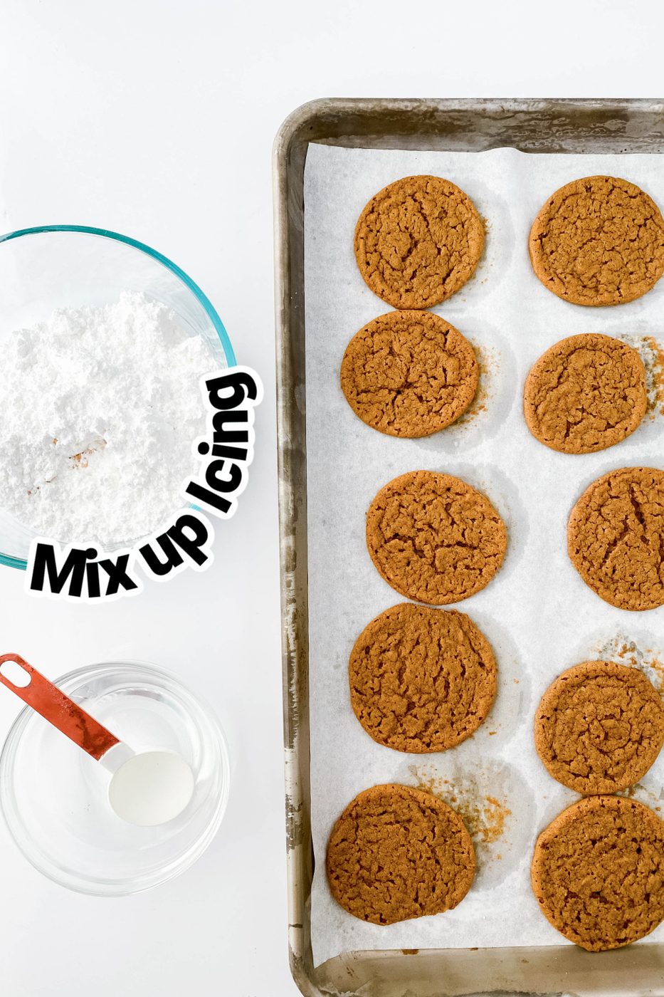 molasses cookies on baking sheet with icing ingredients on side 