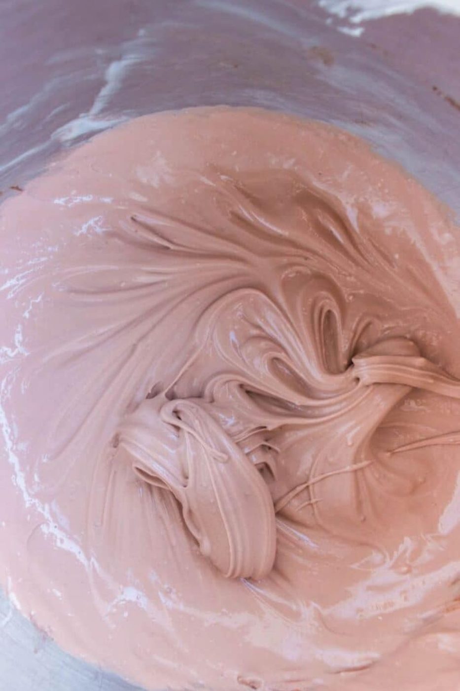 chocolate pudding mixture mixed up in a glass mixing bowl on table 