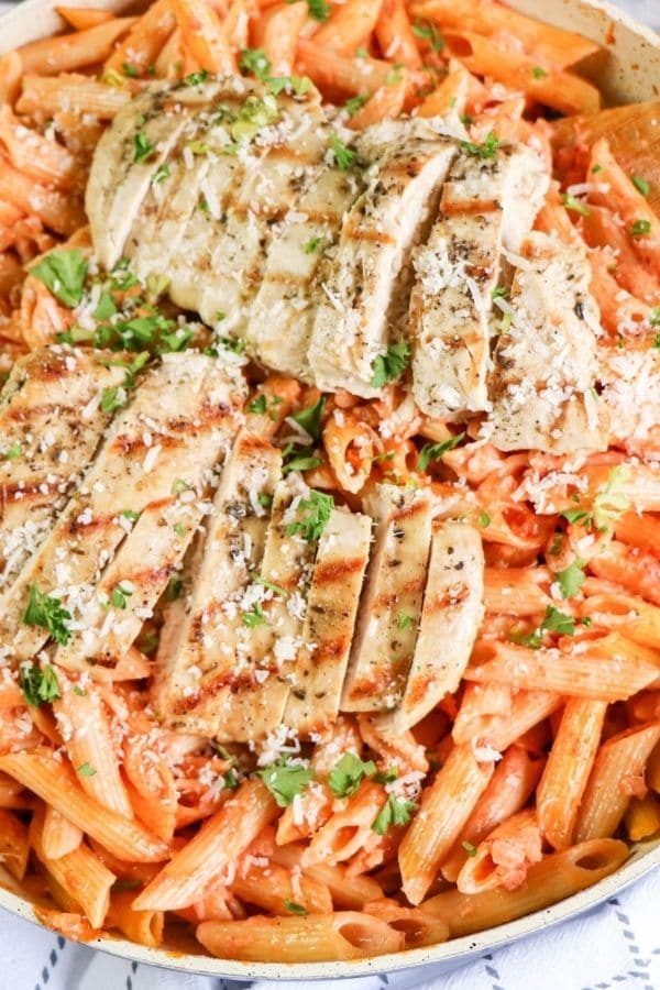 overhead shot of chicken on top of pasta 