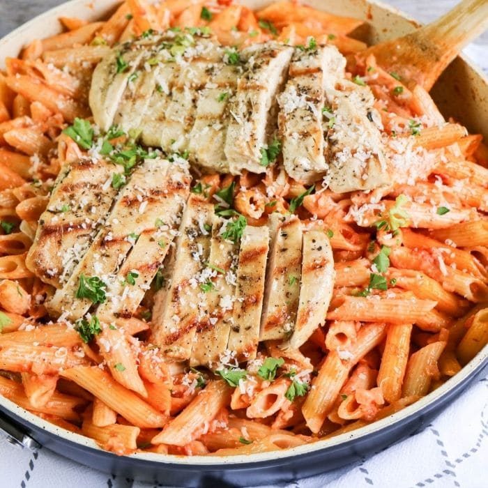 Penne Alla Vodka with Chicken in a skillet on table 