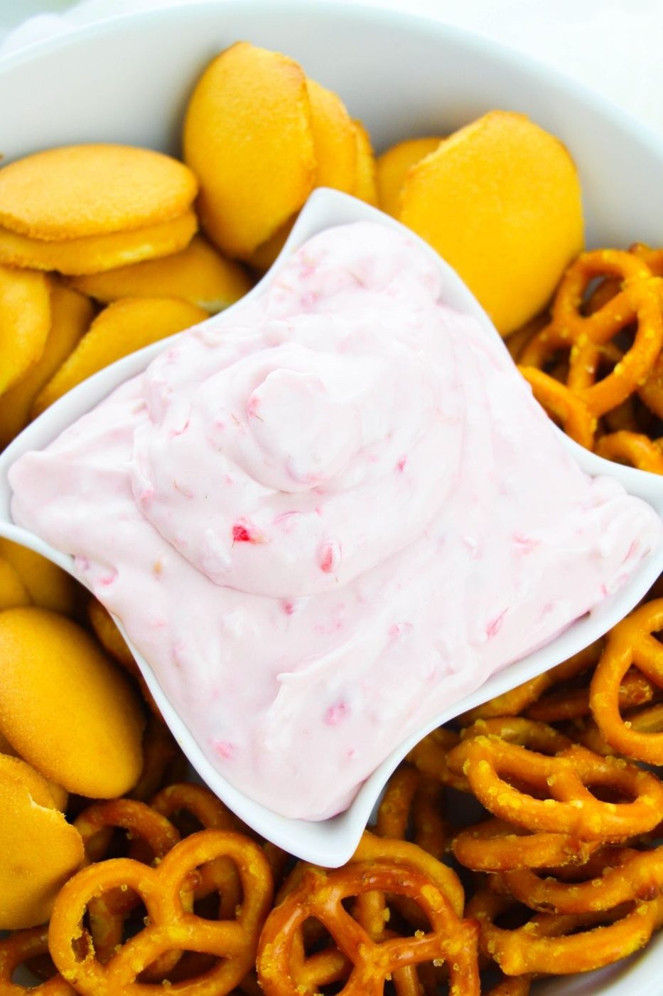overhead shot of dip in a bowl with cookies and pretzels around it