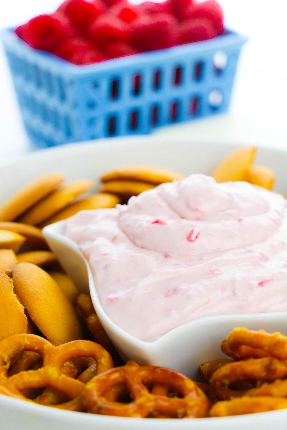 dip in a bowl with cookies and pretzels around it 
