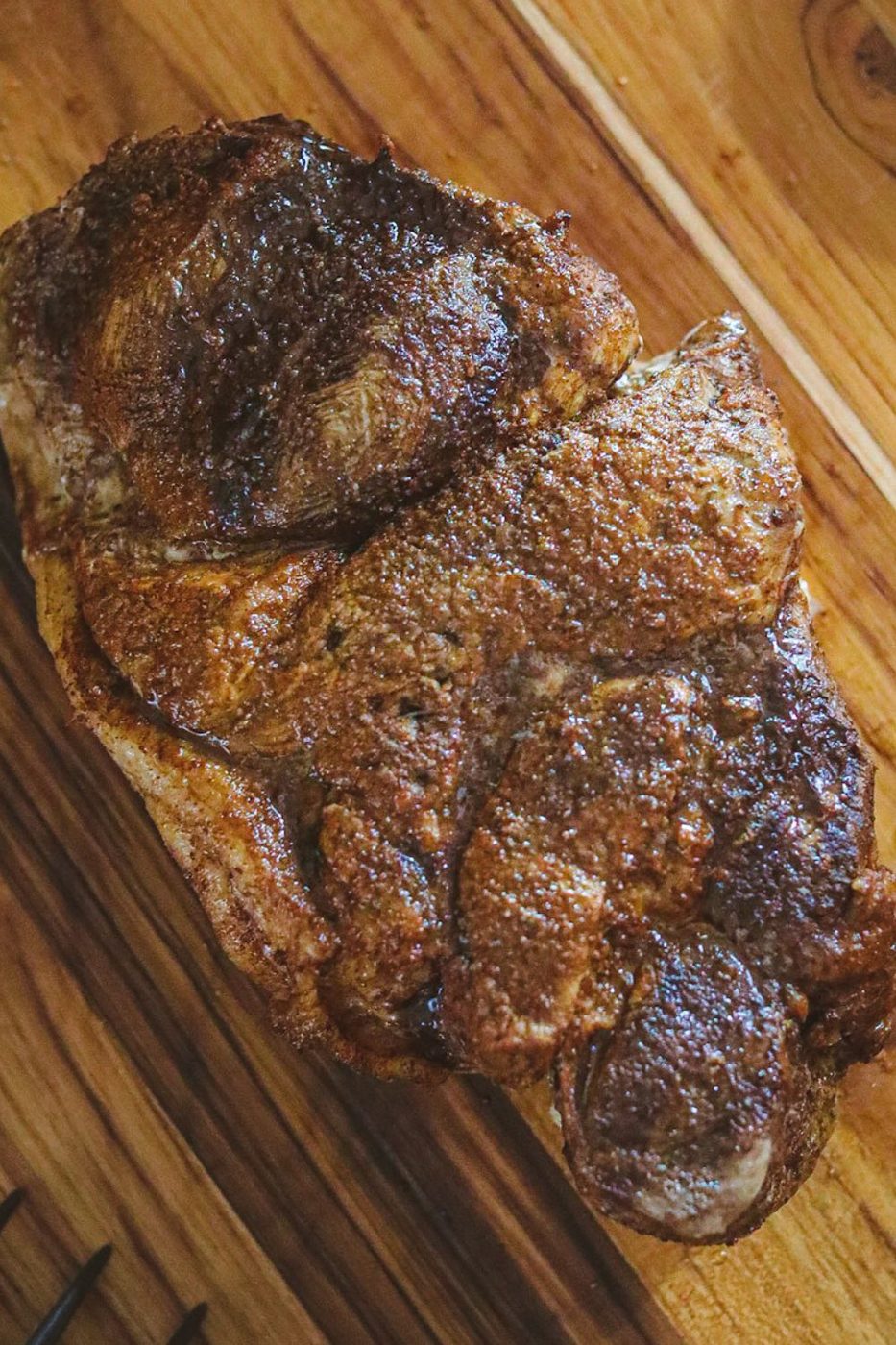overhead shot of a pork roast on wooden cutting board 