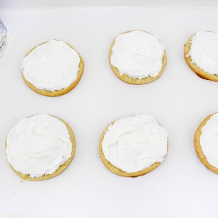 frosted sugar cookies on white table