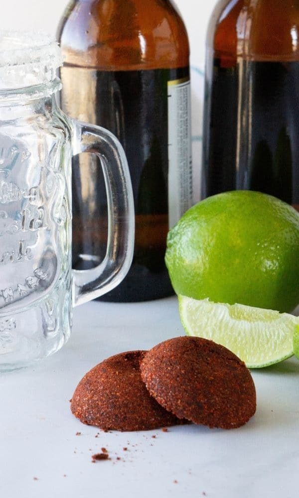beer bombs on table with lime and beer bottles behind it 