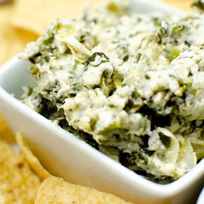 bowl of dip with chips by it