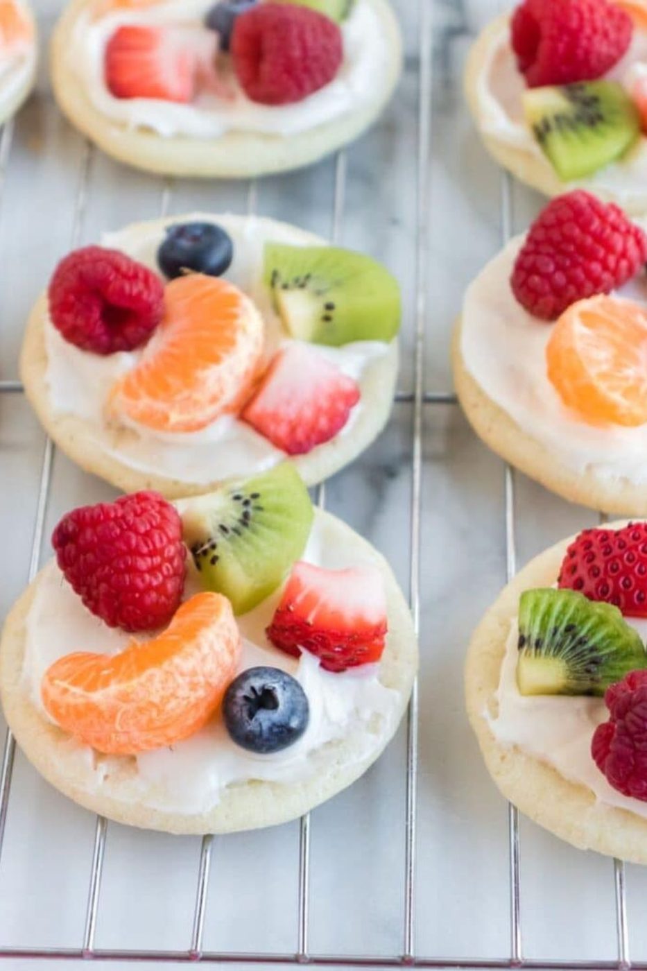 decorated fruit pizza on a cooling rack 
