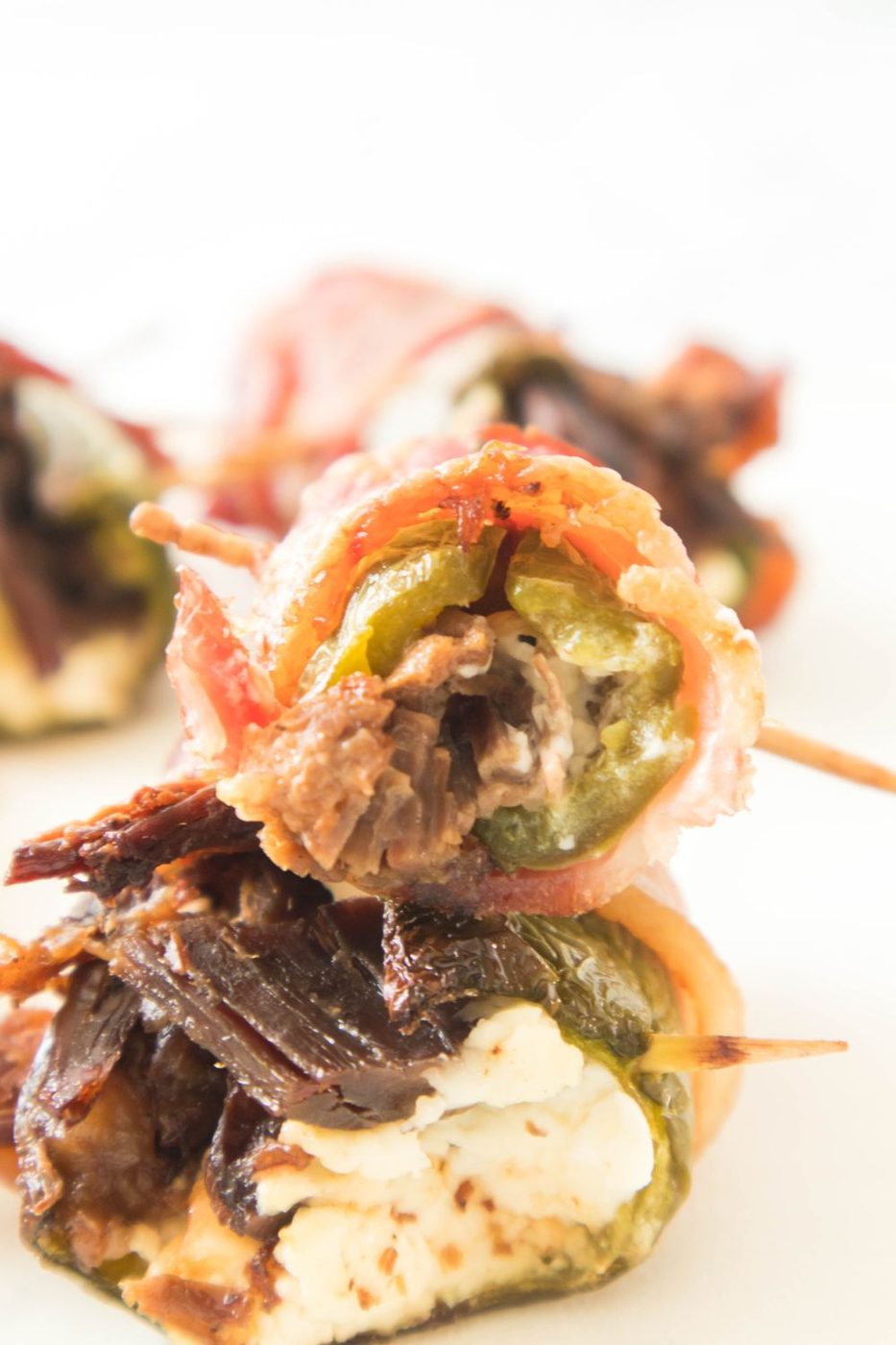 stuffed peppers on a table with toothpicks in them 