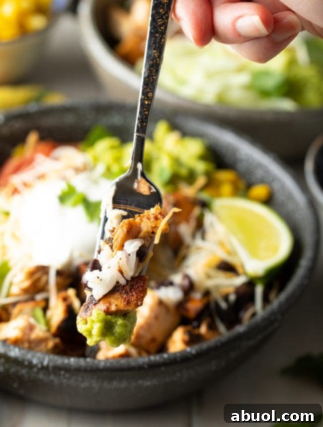 Homemade Chipotle Bowl Recipe - bite of burrito bowl with rice, chicken, and beans