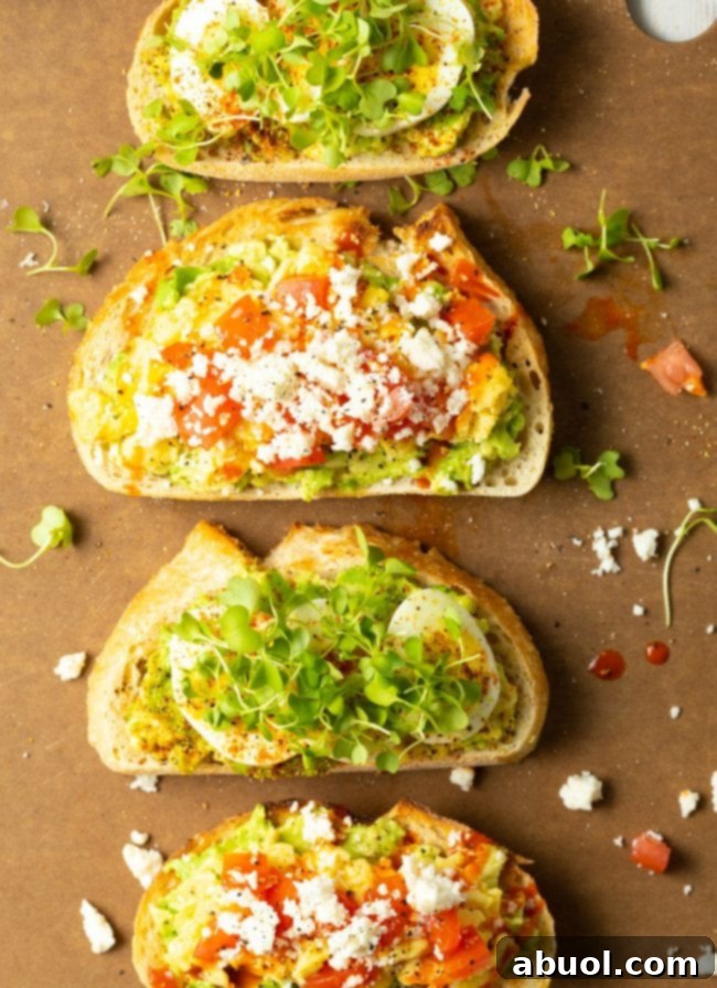 The Perfect Avocado Toast with Egg 9 toasted bread topped with avocado and egg on a serving board