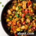 A tantalizing close-up of a serving of Kung Pao Chicken, with tender chicken, vibrant vegetables, and crunchy peanuts.