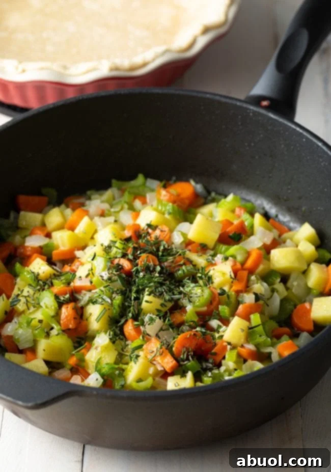 Sauteed mixed vegetables topped with seasoning and fresh herbs in a large skillet, cooking down to develop rich flavors.