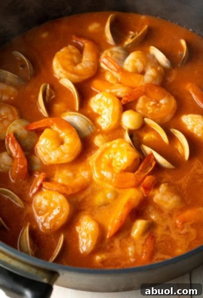Scallops, shrimp, and clams in tomato and wine.