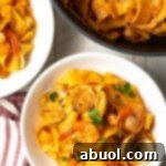 Pappardelle pasta with seafood sauce, garnished.