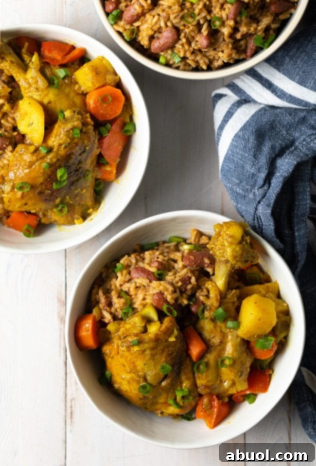 Two bowls of yellow chicken curry with potatoes, carrots, and bell peppers, ready to eat