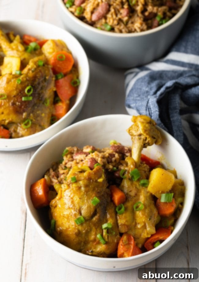 Overhead shot showing the process of making Jamaican curry chicken, with marinated chicken in a pot