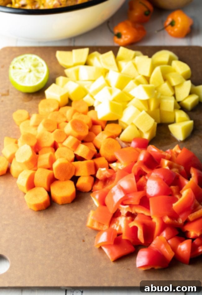 Close-up of chopped potatoes, bell peppers, and carrots, prepped for cooking