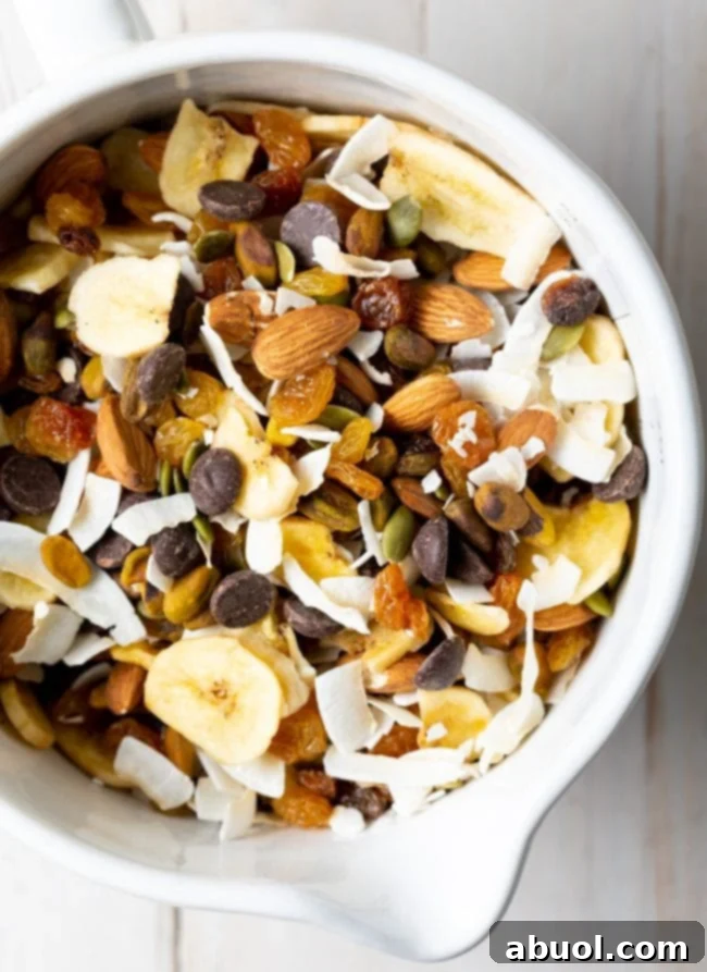 Delicious and healthy homemade trail mix in a white bowl, featuring a blend of seeds and nuts.