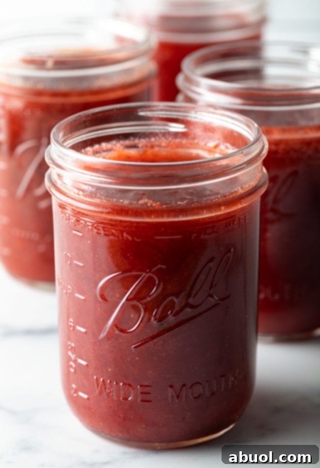 jars of homemade strawberry rhubarb jam without pectin, glowing in natural light