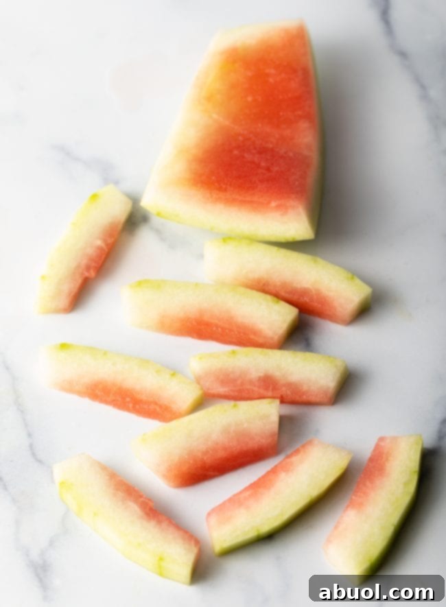 Neatly sliced strips of watermelon rind, prepared for jarring.