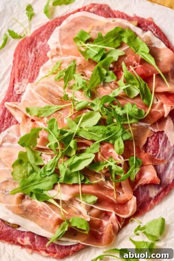 Pounded steak topped with provolone cheese, sautéed wild mushrooms, prosciutto, and fresh arugula.