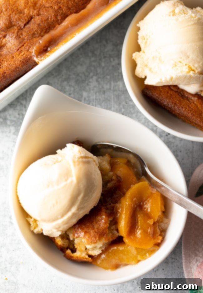 Easy Bisquick peach cobbler garnished with fresh mint, ready to be served