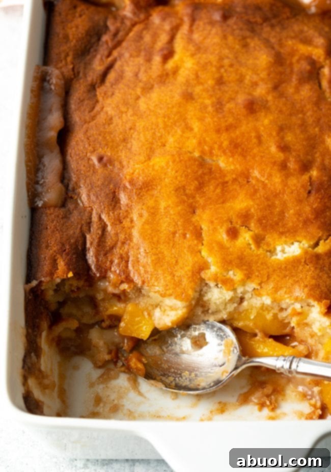 Close-up of Bisquick peach cobbler with a scoop taken out