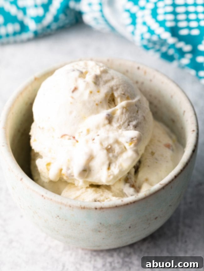 A bowl of freshly made pistachio saffron kulfi ice cream, ready to be frozen and served.